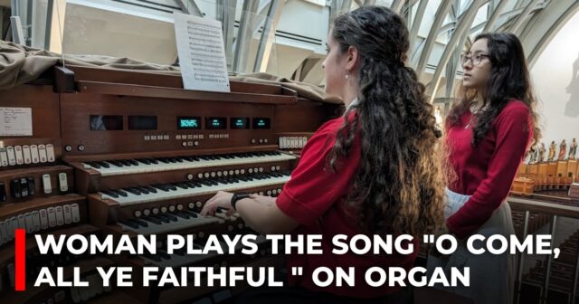 Woman plays the song O Come, All Ye Faithful on organ