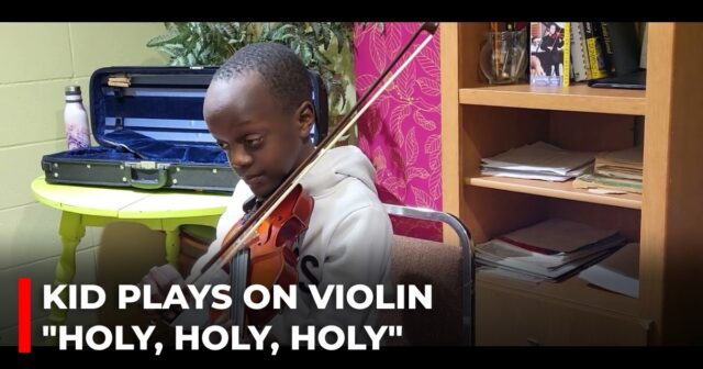 Kid plays on violin Holy, holy, holy